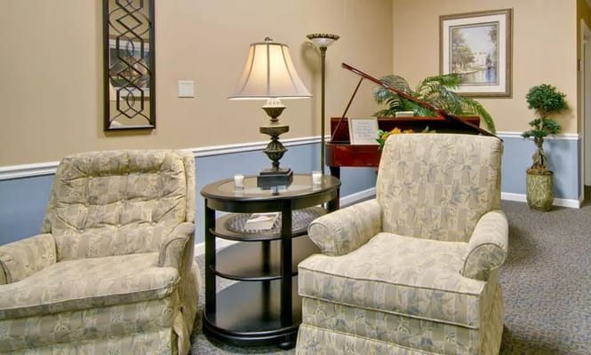 Cozy lounge area with two chairs and a lamp at Asbury Cove