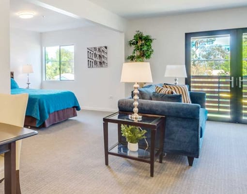 Cozy interior of a private living unit with a bed and seating area