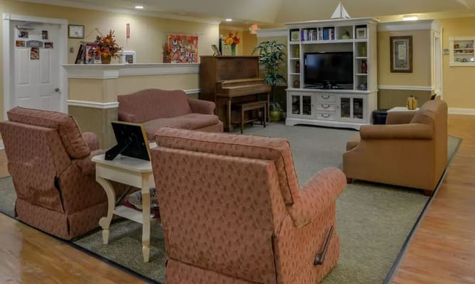 Cozy lounge area with seating and a piano