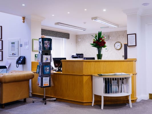 Reception area with floral arrangement and informational display