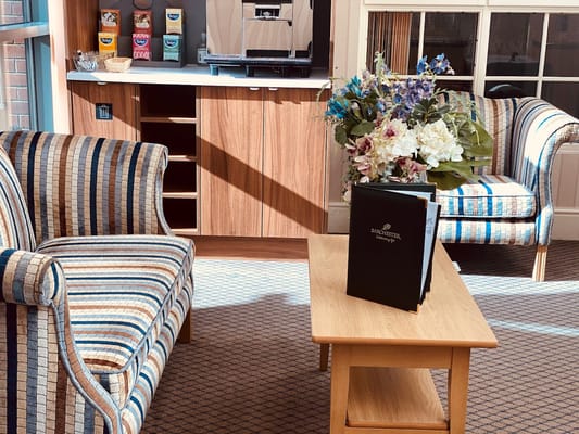 Bright common area with furniture and flowers