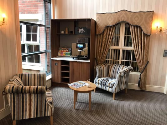 Cozy common area with seating and coffee station