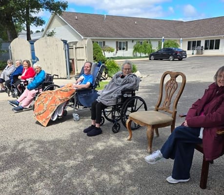 Residents enjoying outdoor seating on a sunny day