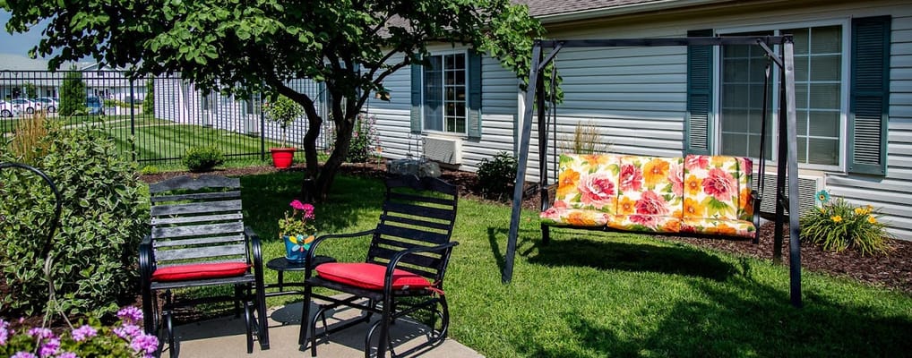 Outdoor seating area with chairs and a swing