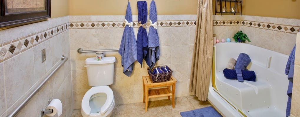Brightly designed bathroom featuring a shower and decorative towels