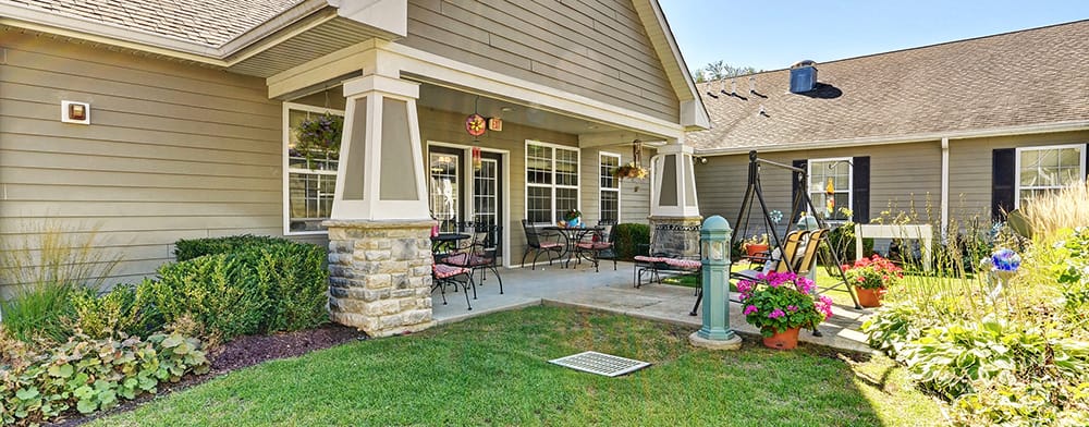Outdoor patio area with colorful flowers and seating