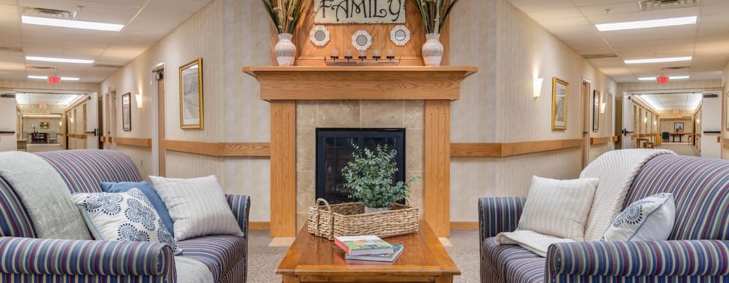 Common area with sofas and a fireplace in the facility.