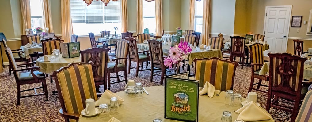 Dining room set up for residents with tables and chairs