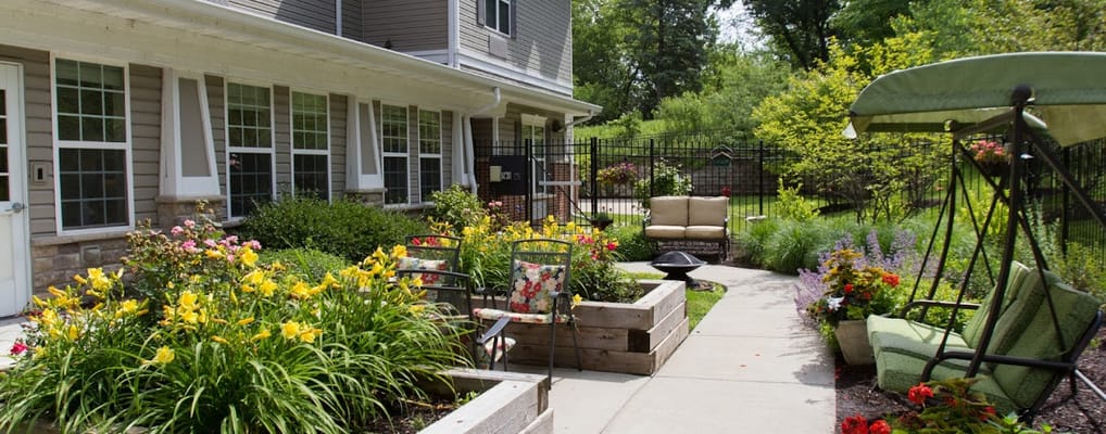 Outdoor garden area with seating and colorful flowers
