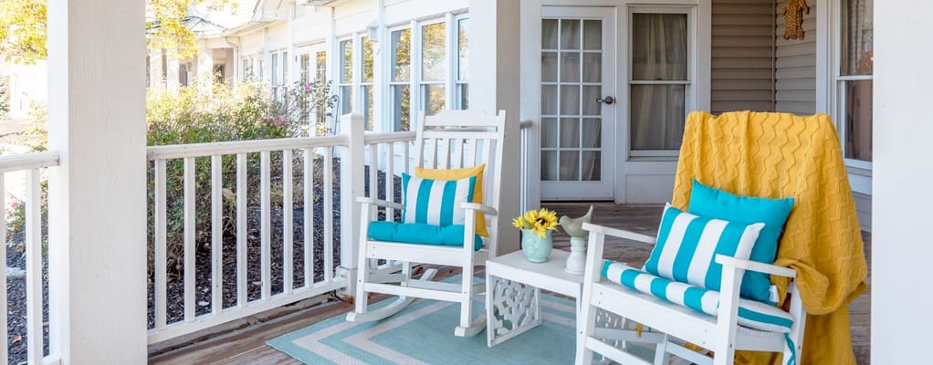 Brightly decorated common area with rocking chairs