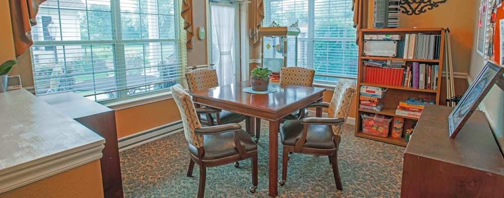 Bright common area with a table and bookshelves