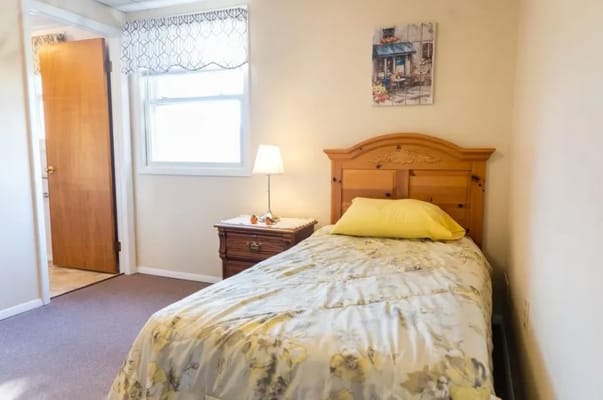 Cozy bedroom with a single bed and warm lighting