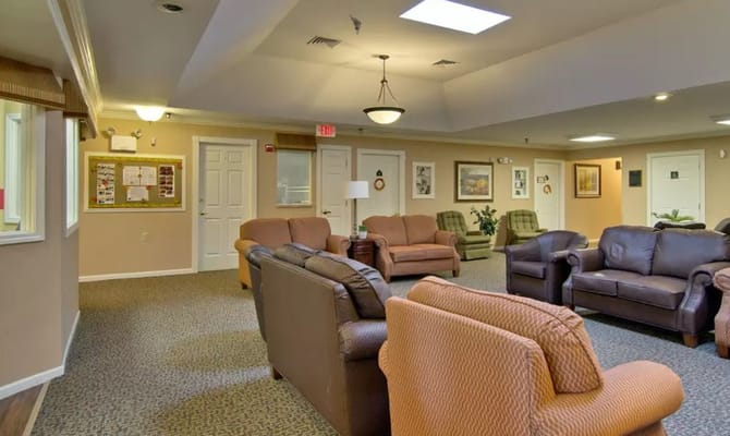 Spacious lounge area with comfortable seating and bulletin board