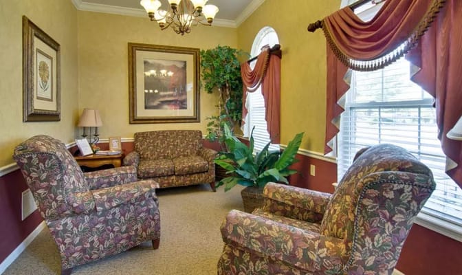 Interior view of a cozy lobby with floral patterned chairs and a couch