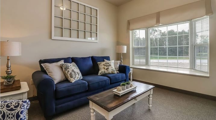 Cozy lounge area with a blue sofa and window seat