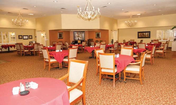 Dining room with red tablecloths and seating