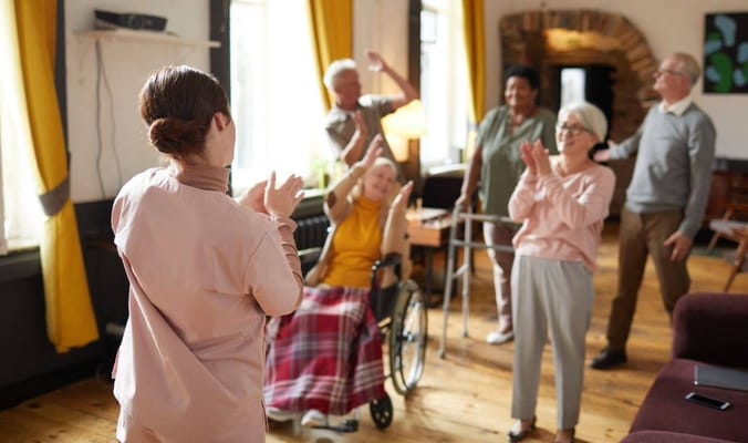 Residents and staff enjoying a lively activity in a common area
