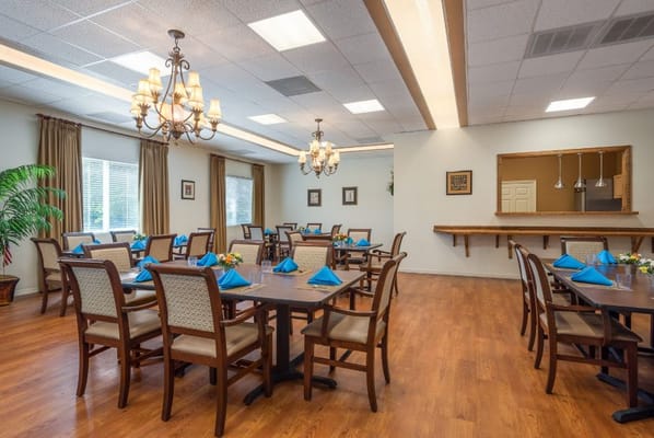 Bright dining room with tables set for a meal