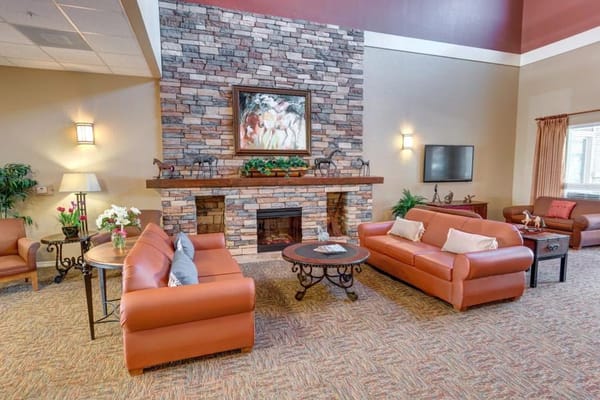 Living room with stone fireplace and comfortable seating