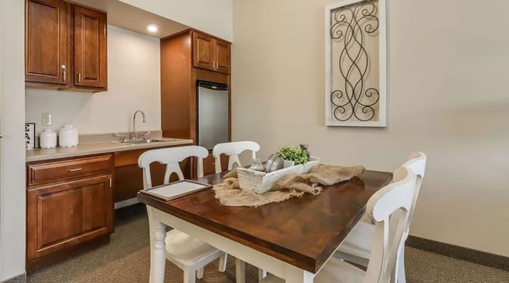 Cozy dining area with a wooden table and white chairs