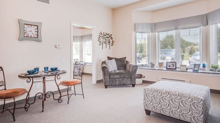 A cozy living room with a round table and comfortable seating