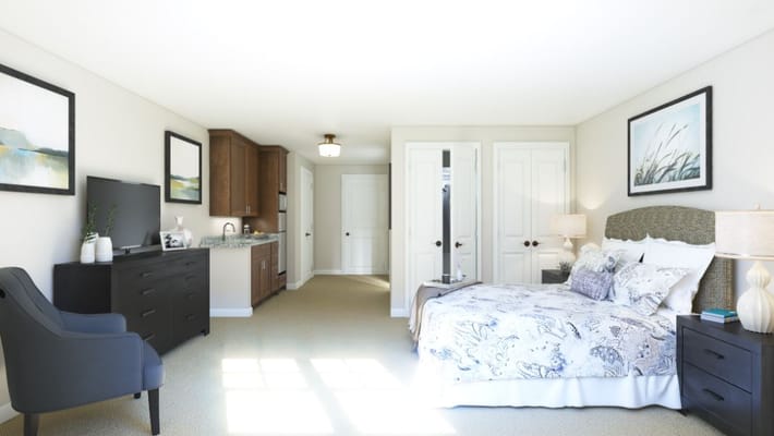 Interior view of a private resident room with bed and furnishings