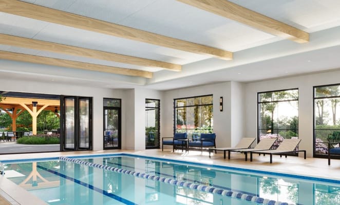 Indoor swimming pool area with comfortable seating
