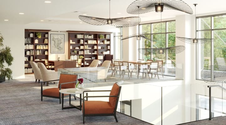 Brightly lit common area with seating and bookshelves