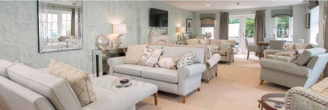 Lounge area with light-colored sofas and decorative pillows