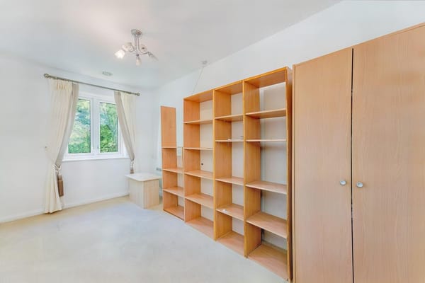 A living space with shelving and natural light