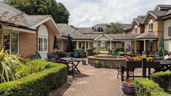 Residents enjoying an outdoor courtyard with seating