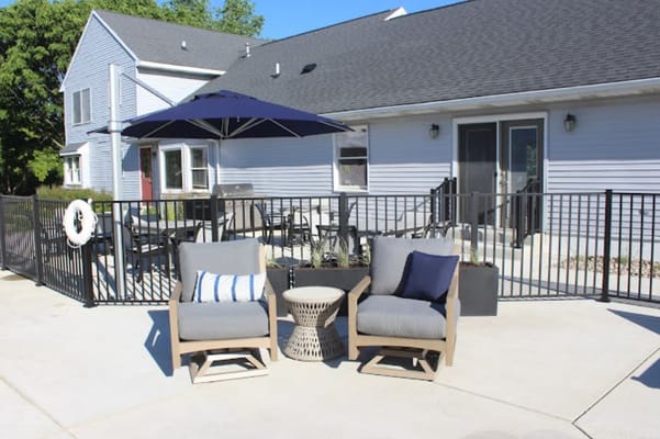 Comfortable seating area with chairs and umbrella on the patio