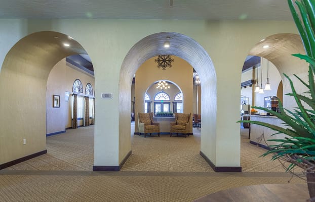 Entrance to the Caliche Senior Living lobby featuring arched doorways and seating area