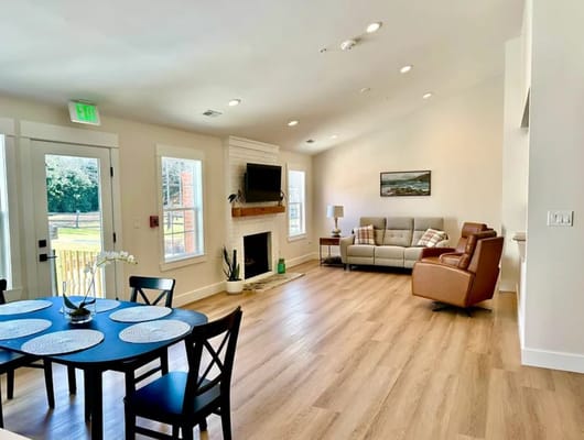 Bright living room with seating and dining area in senior home