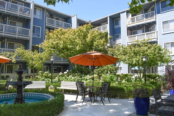 Courtyard with seating and orange umbrellas