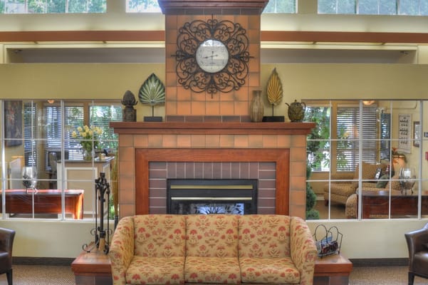 Cozy common area with decorative fireplace and seating