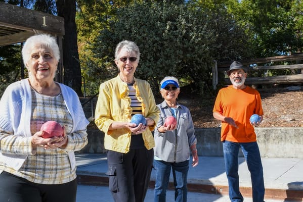 Residents participating in an outdoor bocce ball game