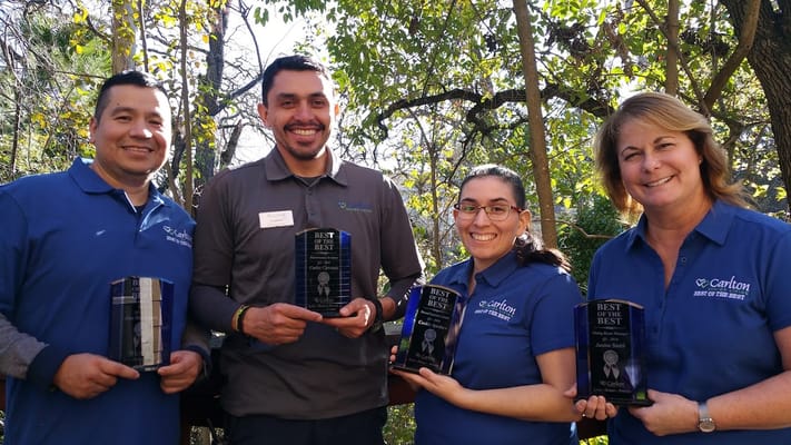 Staff members celebrating awards in a garden
