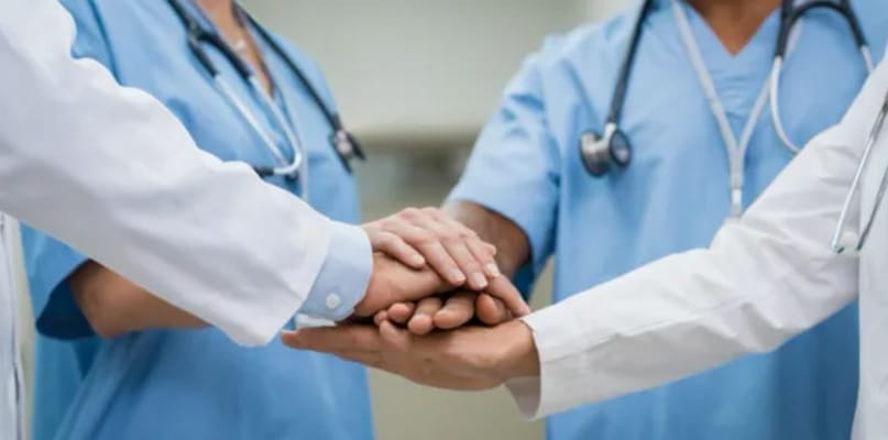 Hands of healthcare professionals stacked together