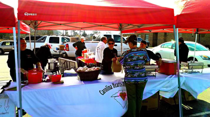 Staff serving food at an outdoor event