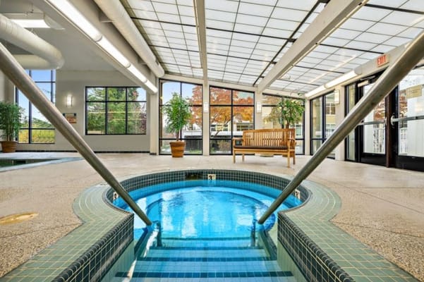 Indoor spa area with hot tub and seating