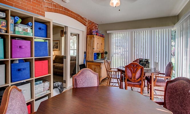 Bright common area with seating and colorful storage bins