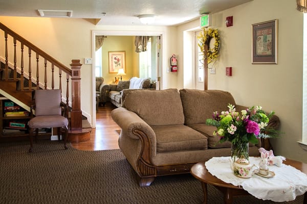 Cozy common area with seating and floral arrangements