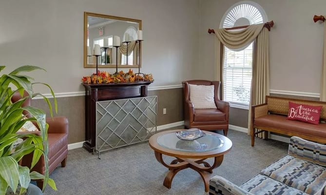 Comfortable living room with armchairs and a decorative mantel
