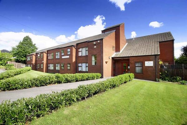 Exterior view of Chell Green Court with landscaped grounds