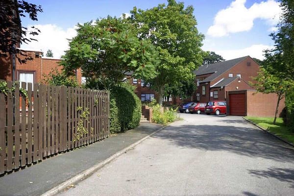 Outdoor view of Chell Green Court with trees and buildings