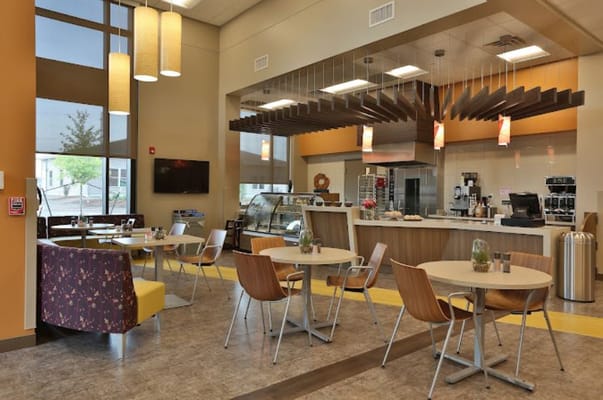Bright and inviting dining area with tables and a service counter