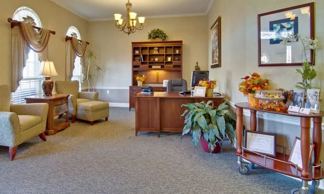 Cozy reception area featuring seating and a desk.