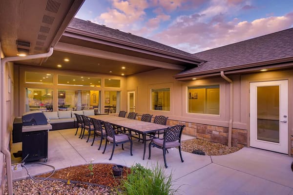 Outdoor patio area with seating and grill