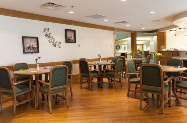 Bright common area with tables and chairs for residents